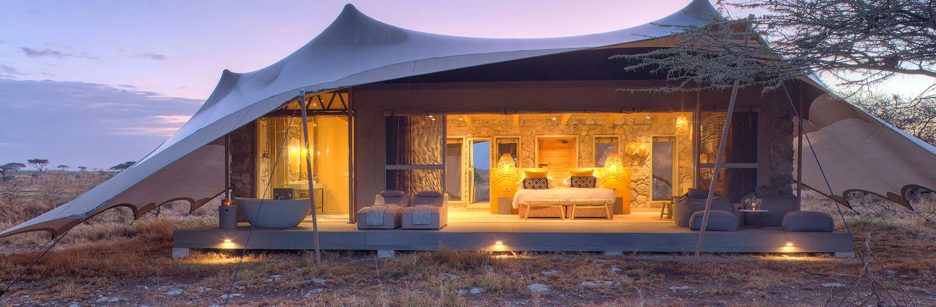 Best Luxury Lodges Serengeti 2026 tented camp at sunset overlooking Serengeti plains
